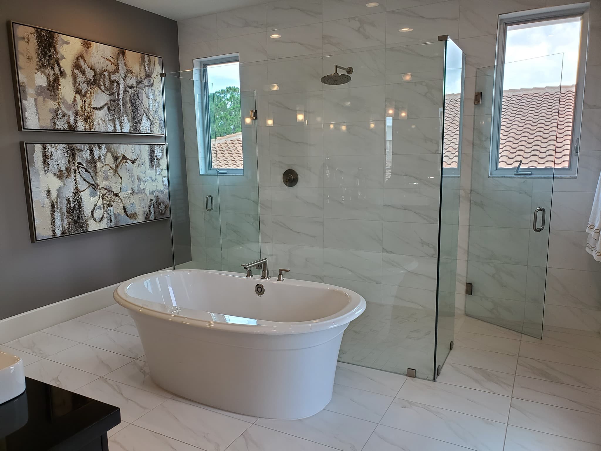 Contemporary marble master bathroom with freestanding tub